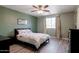 Bedroom with a queen bed, ceiling fan, and light wood floors at 16636 S 34Th Way, Phoenix, AZ 85048