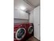 Bright laundry room features red LG washer and dryer, ample cabinetry, and built-in storage at 16636 S 34Th Way, Phoenix, AZ 85048