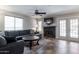 Living room with a sectional sofa, fireplace, and patio access at 16636 S 34Th Way, Phoenix, AZ 85048