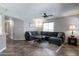 Living room with a sectional sofa, ceiling fan, and tile flooring at 16636 S 34Th Way, Phoenix, AZ 85048