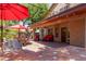 Relaxing backyard patio with built-in BBQ, seating area, and red umbrellas at 16636 S 34Th Way, Phoenix, AZ 85048