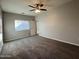 Spacious bedroom with carpeted floors and ceiling fan at 1727 W Pollack St, Phoenix, AZ 85041