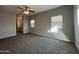 Spacious carpeted bedroom with window and ceiling fan at 1727 W Pollack St, Phoenix, AZ 85041