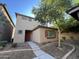 Two-story tan house with red door and landscaping at 1727 W Pollack St, Phoenix, AZ 85041