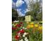 Beautiful backyard garden featuring colorful flowers and a shed at 178 W Harrison St, Chandler, AZ 85225