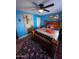 Bedroom with wooden bed frame, blue walls, and area rug at 178 W Harrison St, Chandler, AZ 85225