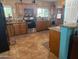 Spacious kitchen with wood cabinets, tile floors, and stainless steel appliances at 178 W Harrison St, Chandler, AZ 85225