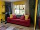 Cozy living room with red couch, large mirror, and colorful rug at 178 W Harrison St, Chandler, AZ 85225