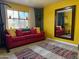 Cozy living room with red couch, large mirror, and colorful rug at 178 W Harrison St, Chandler, AZ 85225