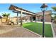 Backyard with pergola, artificial turf, and pool at 18404 W Long Lake Rd, Goodyear, AZ 85338