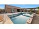 Inviting backyard oasis featuring a sparkling pool, expansive patio, and pergola at 18404 W Long Lake Rd, Goodyear, AZ 85338