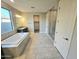 Bathroom features a large tub, granite counters, and a walk-in shower at 18404 W Long Lake Rd, Goodyear, AZ 85338