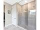 Bathroom with a glass shower featuring decorative tile work and a closet/changing area at 18404 W Long Lake Rd, Goodyear, AZ 85338