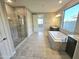 Bathroom features a large tub, walk-in shower, and granite counters at 18404 W Long Lake Rd, Goodyear, AZ 85338