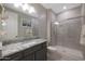 Bathroom with granite countertop and walk-in shower at 18404 W Long Lake Rd, Goodyear, AZ 85338