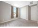 Bedroom with window and double door closet at 18404 W Long Lake Rd, Goodyear, AZ 85338