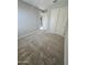 Carpeted bedroom with view to hallway, light gray walls, and a closet with double doors at 18404 W Long Lake Rd, Goodyear, AZ 85338