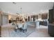 Kitchen island and dining area with a chandelier and access to Gathering room at 18404 W Long Lake Rd, Goodyear, AZ 85338