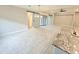 Open living and dining area with a barn door, recessed lighting and tile flooring throughout at 18404 W Long Lake Rd, Goodyear, AZ 85338