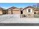 Two-story house with a three-car garage and desert landscaping at 18404 W Long Lake Rd, Goodyear, AZ 85338