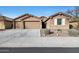 Brick home with 3-car garage and landscaped front yard at 18404 W Long Lake Rd, Goodyear, AZ 85338