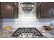 Modern kitchen with gas cooktop and white subway tile backsplash at 18404 W Long Lake Rd, Goodyear, AZ 85338