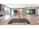 Granite kitchen island with sink and modern faucet at 18404 W Long Lake Rd, Goodyear, AZ 85338