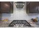 Gas cooktop and stainless steel range hood in kitchen at 18404 W Long Lake Rd, Goodyear, AZ 85338