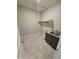 Laundry room with tile floor, a small sink, and shelving at 18404 W Long Lake Rd, Goodyear, AZ 85338