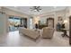 Living room with sliding doors to backyard and view to kitchen at 18404 W Long Lake Rd, Goodyear, AZ 85338