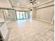 Spacious living room showcasing a barn door, tile flooring, and sliding glass doors to the outdoors at 18404 W Long Lake Rd, Goodyear, AZ 85338