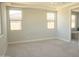 Bright main bedroom with neutral walls, carpet flooring, and large windows offering plenty of natural light at 18404 W Long Lake Rd, Goodyear, AZ 85338