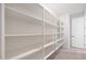 Bright white pantry offers extensive shelving at 18404 W Long Lake Rd, Goodyear, AZ 85338