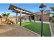 Beautiful pool area with pergola, artificial turf and patio at 18404 W Long Lake Rd, Goodyear, AZ 85338