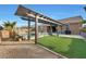 Inviting pool area with pergola, artificial turf, and patio furniture at 18404 W Long Lake Rd, Goodyear, AZ 85338