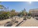 Relaxing backyard patio with seating area, umbrella, and desert landscaping at 18509 N Toya St, Maricopa, AZ 85138