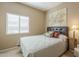 Bright bedroom with a queen-size bed and large window at 18509 N Toya St, Maricopa, AZ 85138