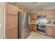 Modern kitchen with stainless steel appliances and light wood cabinets at 18509 N Toya St, Maricopa, AZ 85138