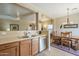 Kitchen with stainless steel appliances, light wood cabinets, and dining area at 18509 N Toya St, Maricopa, AZ 85138