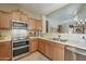 Kitchen features stainless steel appliances and light wood cabinetry at 18509 N Toya St, Maricopa, AZ 85138