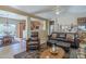 Spacious living room with leather furniture, a large TV, and a view into the kitchen at 18509 N Toya St, Maricopa, AZ 85138