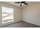 Well-lit bedroom featuring a large window and ceiling fan at 19241 N 4Th Pl, Phoenix, AZ 85024