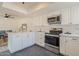 Modern kitchen with white cabinets and stainless steel appliances at 19241 N 4Th Pl, Phoenix, AZ 85024