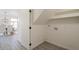 Convenient laundry area with shelving and tile floor at 19241 N 4Th Pl, Phoenix, AZ 85024