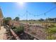 Landscaped backyard with a stone retaining wall and golf course views at 19778 N Coyote Lakes Pkwy, Surprise, AZ 85378