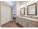 Bathroom with double vanity and a view into bedroom at 19778 N Coyote Lakes Pkwy, Surprise, AZ 85378