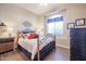 Cozy bedroom with a comfortable bed and charming decor at 19778 N Coyote Lakes Pkwy, Surprise, AZ 85378