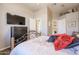 Well-lit bedroom with a dresser and large TV at 19778 N Coyote Lakes Pkwy, Surprise, AZ 85378