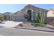 Single-story house with a two-car garage and landscaped front yard at 19778 N Coyote Lakes Pkwy, Surprise, AZ 85378