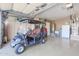 Garage interior with golf cart and storage cabinets at 19778 N Coyote Lakes Pkwy, Surprise, AZ 85378